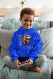 Young boy sitting holding a retro game controller wearing a bright blue ROARSOME kids dinosaur hoodie.